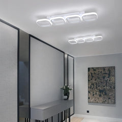 Modern interior design with ceiling lights, mirror, and abstract painting.