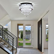 Modern interior with a chandelier, staircase, and view of a house exterior.