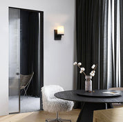 Modern interior with a round black dining table, chairs, and decorative elements.