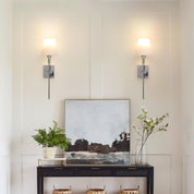 Modern interior with wall sconces, a console table, and decorative items.