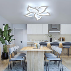Modern kitchen with a ceiling light fixture, dining table, and chairs.