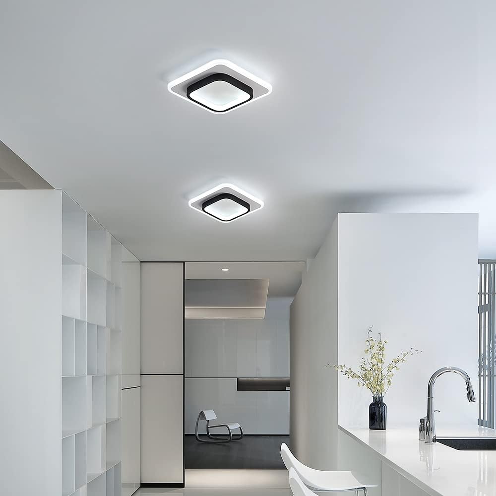 Modern kitchen with white cabinets, a sink, and decorative elements.