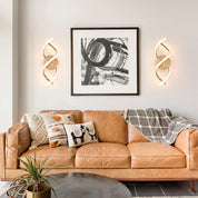 Modern living room with a brown leather sofa, decorative pillows, and wall art.