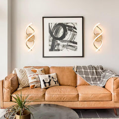 Modern living room with a brown leather sofa, decorative pillows, and wall art.