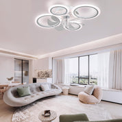 Modern living room with a ceiling light fixture, sofa, and large windows.