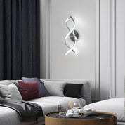 Modern living room with a decorative wall light fixture above a sofa.