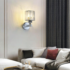 Modern living room with a wall lamp, sofa, and decorative pillows.