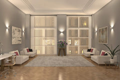 Modern living room with gray walls, white furniture, and decorative elements.
