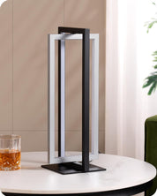 Modern table lamp with a glass of whiskey on a table against a neutral background