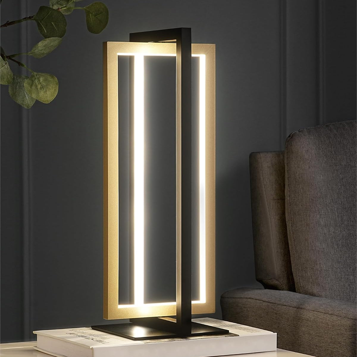 Modern table lamp with a sleek design on a surface next to a sofa.