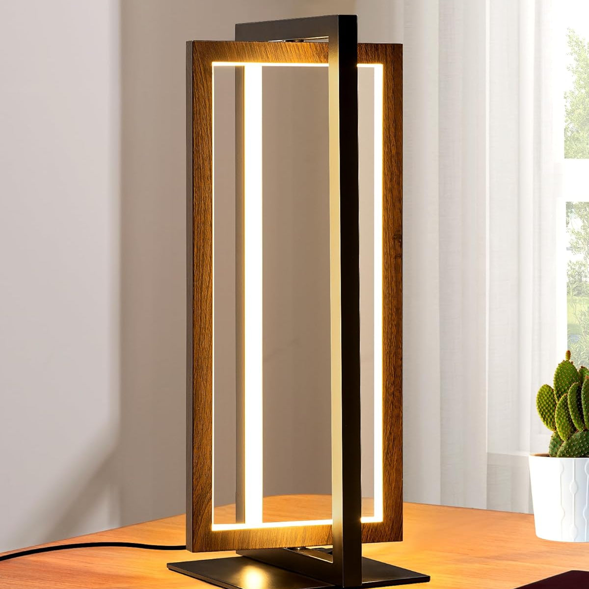 Modern table lamp with wooden frame and LED light on a desk.