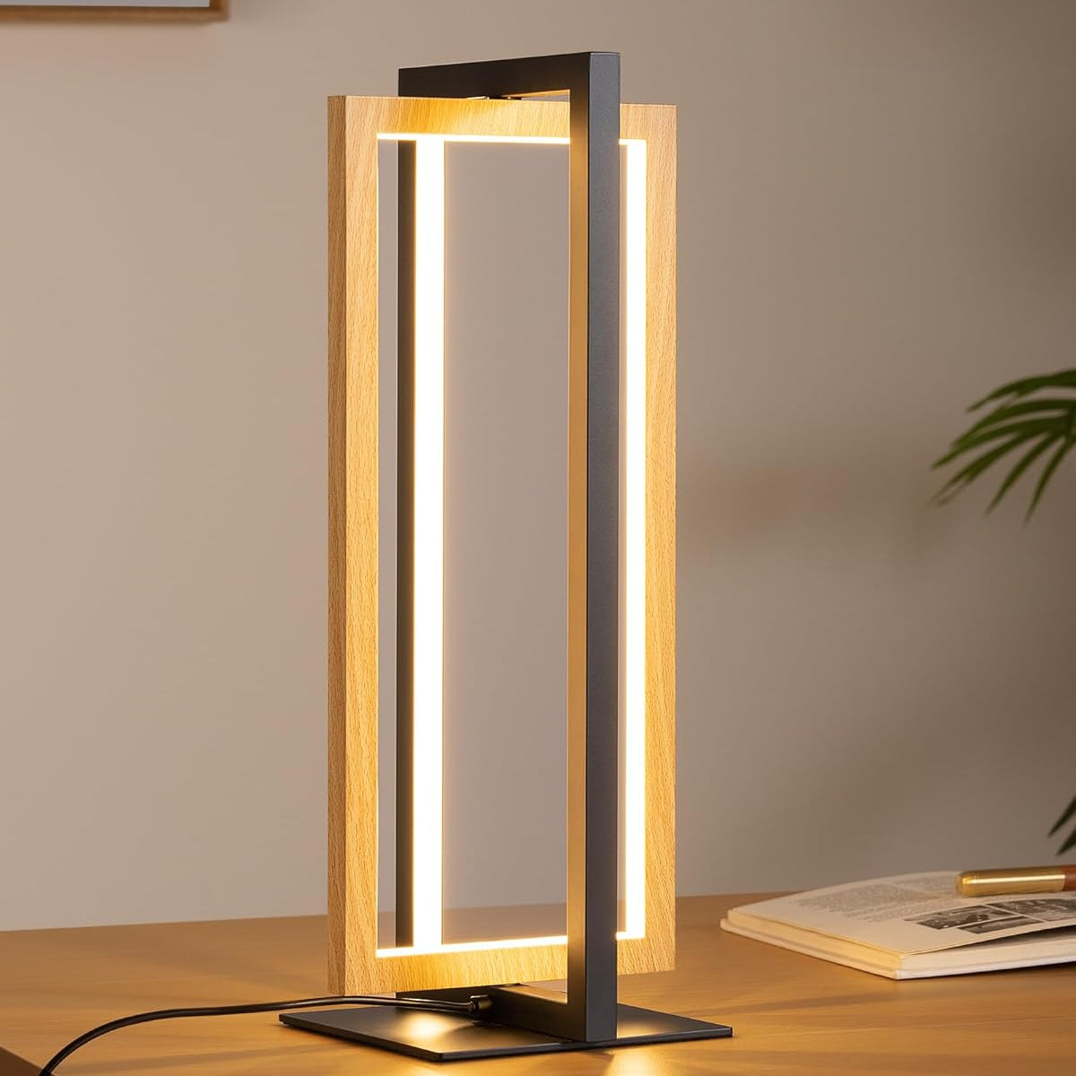 Modern table lamp with wooden frame and black base on a wooden surface.