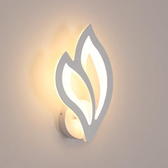 Modern wall light fixture with leaf-like design on a neutral background