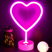 Neon heart-shaped light on a purple background