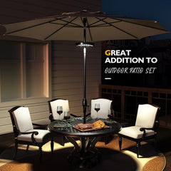 Outdoor patio set with table, chairs, and umbrella at night.