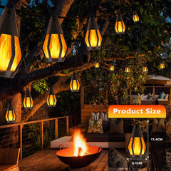 Outdoor setting with hanging lantern-like lights and a fire pit.