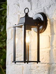 Outdoor wall light fixture on a textured white wall
