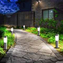 Pathway illuminated by solar-powered outdoor lights at night.