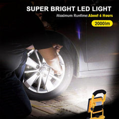 Person changing a tire with a super bright LED light illuminating the area, highlighting its brightness and runtime.