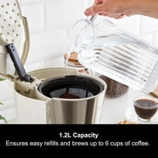 Person pouring water into a coffee maker with text about capacity.
