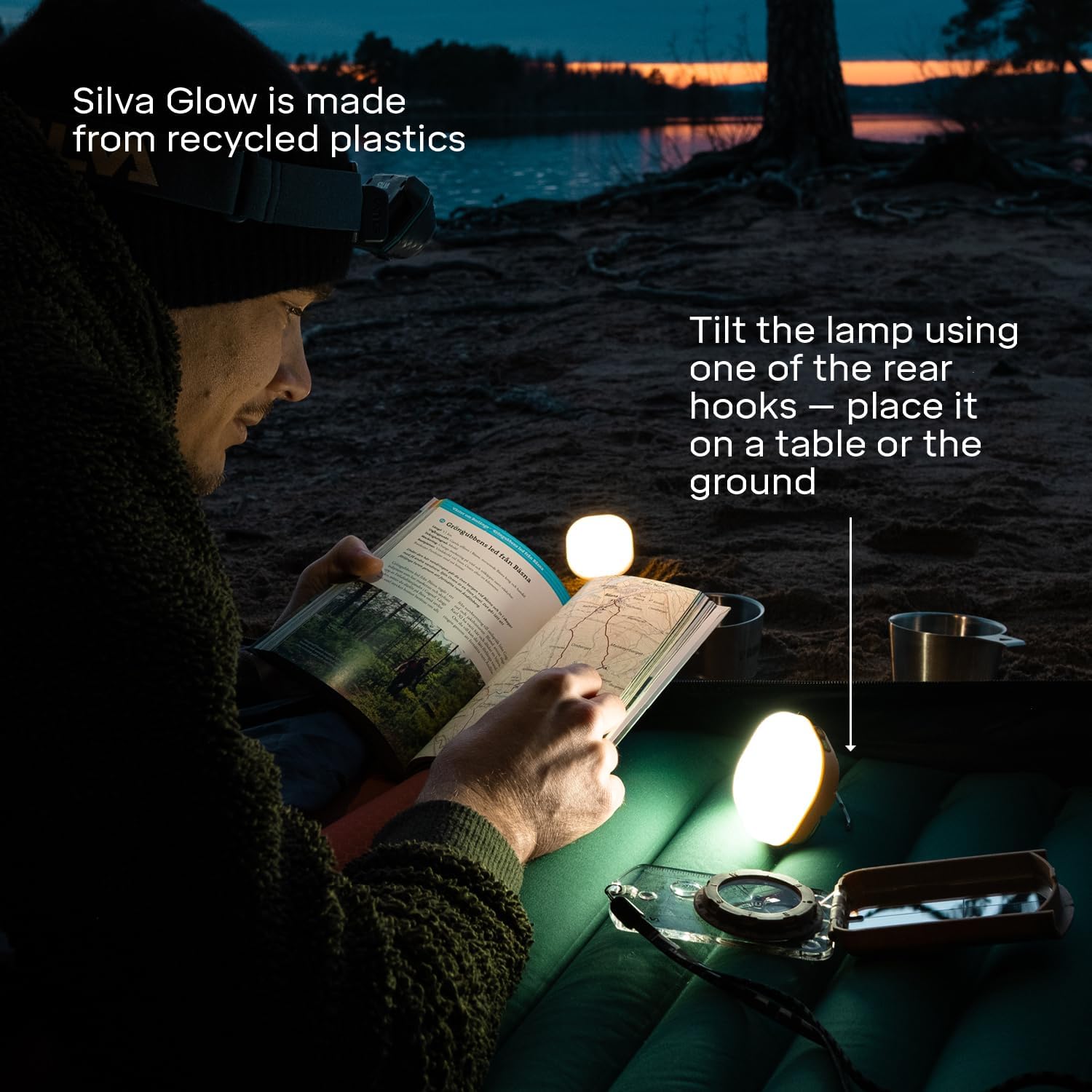 Person reading a book with Silva Glow light on a beach at night