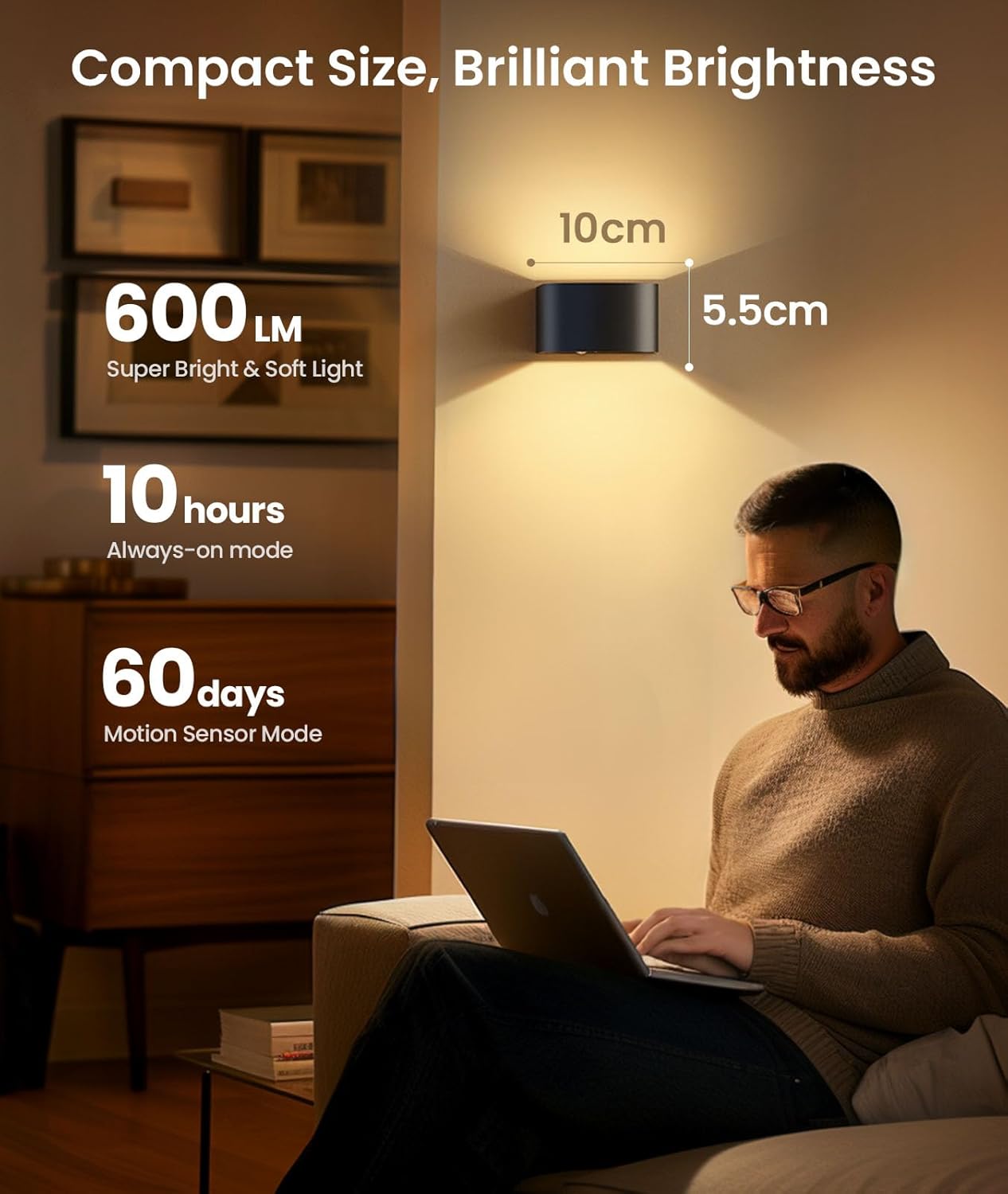 Person using a laptop with a wall-mounted light fixture in a room.