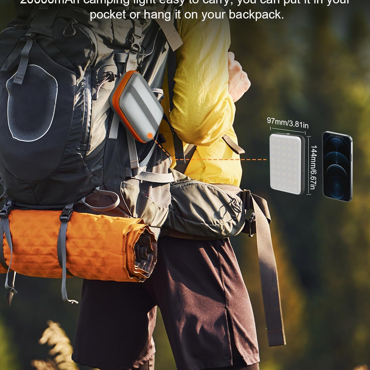 Person wearing a backpack with a camping light, surrounded by nature.