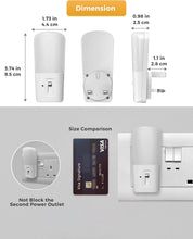 Size comparison of a small electronic device with a Visa card and power outlet.