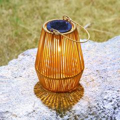Solar-powered lantern on a rock with grass in the background