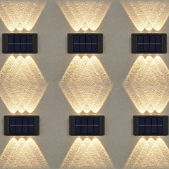 Solar-powered wall lights on a textured wall