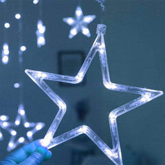 Star-shaped LED string light held by a hand against a dark background