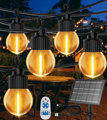 String lights with solar panel and remote control on a dark background