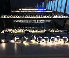 String of lights on a reflective surface with a blurred indoor background