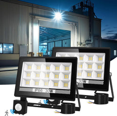 Three LED flood lights with a building in the background