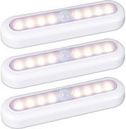 Three white LED motion sensor lights on a light gray background