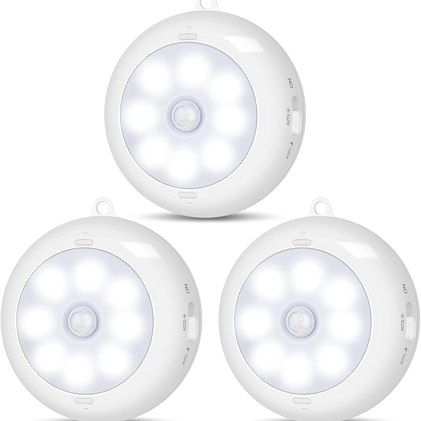 Three white motion sensor lights on a white background