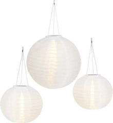 Three white spherical pendant lights hanging against a white background