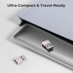 Two Pink USB drives on a surface with a laptop and text 'Ultra-Compact & Travel-Ready'.