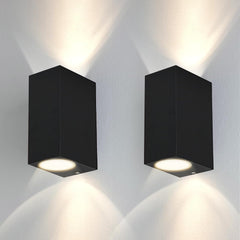 Two black square wall lights on a white wall