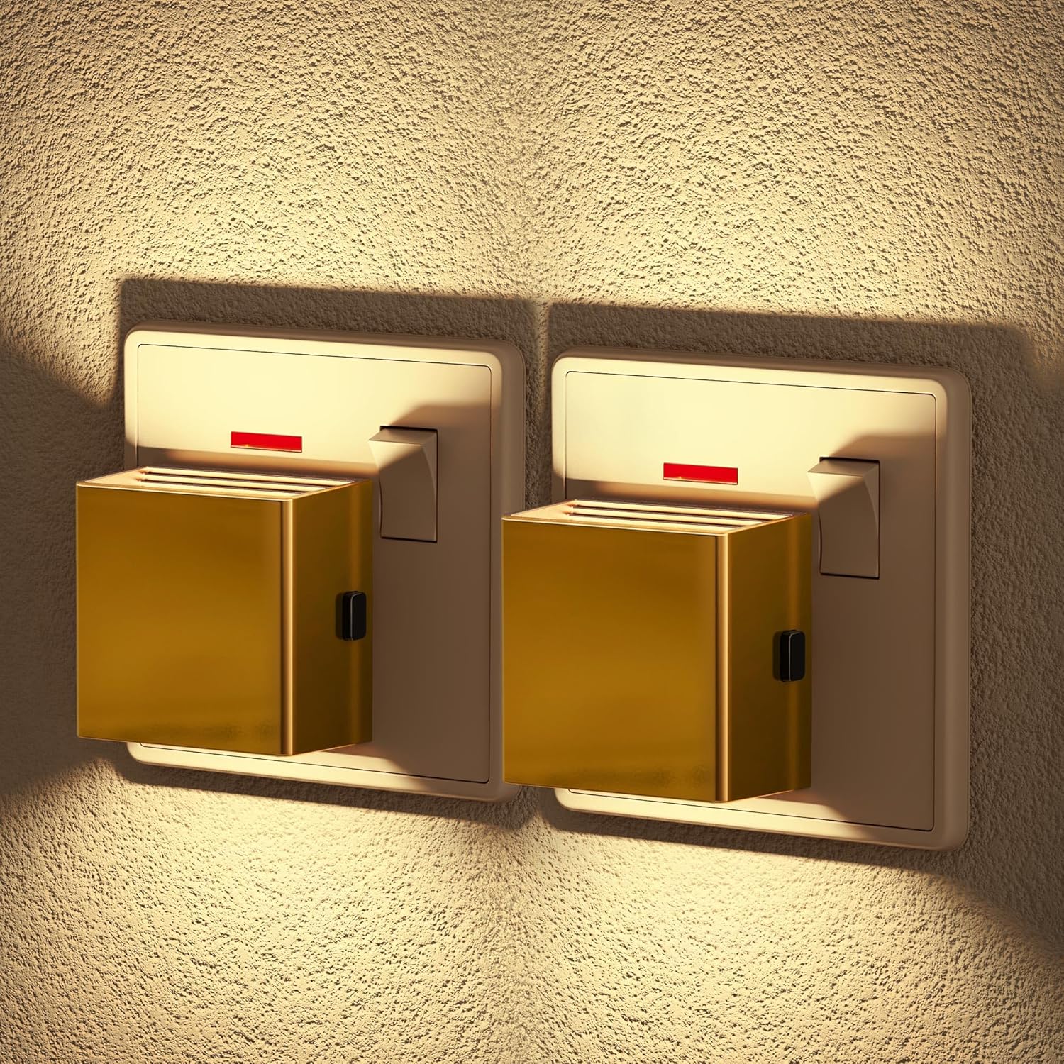 Two gold night lights on a textured wall.