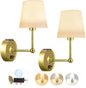 Two gold wall sconces with beige lampshades on a white background.