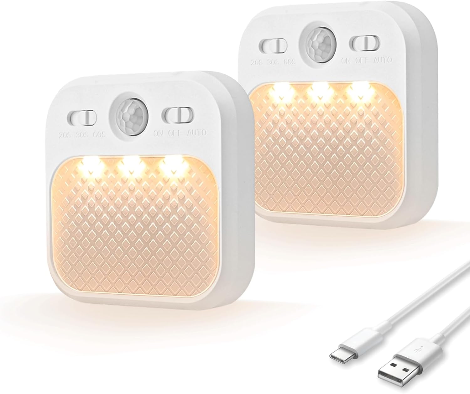 Two motion sensor lights with a USB cable on a white background