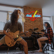 Two musicians playing guitar and drums in a room with a 'Rock & Roll' neon sign.