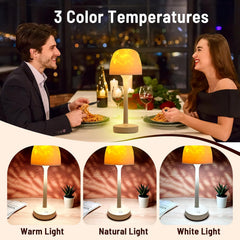 Two people enjoying a meal together with a table lamp showing three color temperature options.