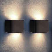 Two square wall lights on a textured wall