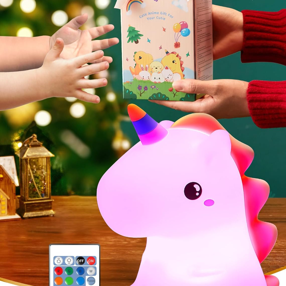 Unicorn-shaped night light with remote control, gift box, and hands reaching towards it on a festive background.