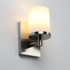 Wall-mounted light fixture with a glass shade on a gray background