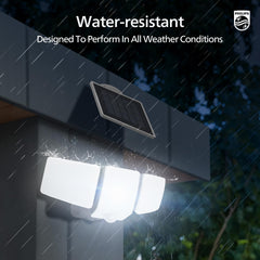 Water-resistant outdoor light fixture with solar panel on a rainy night, Philips logo visible.