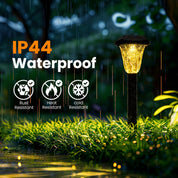 Waterproof outdoor light fixture in a garden with rain, labeled IP44 and resistant to rust, heat, and cold.