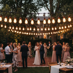 Wedding reception with string lights and guests in an outdoor setting
